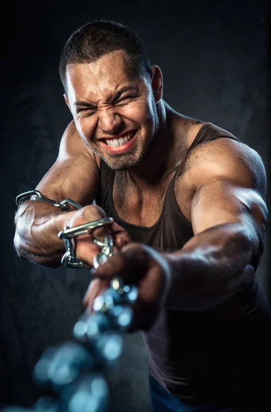 Muscular man pulling the chain — Stock Photo, Image