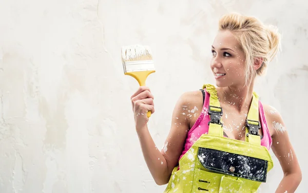 Woman in coverall with paint brush — Stock Photo, Image