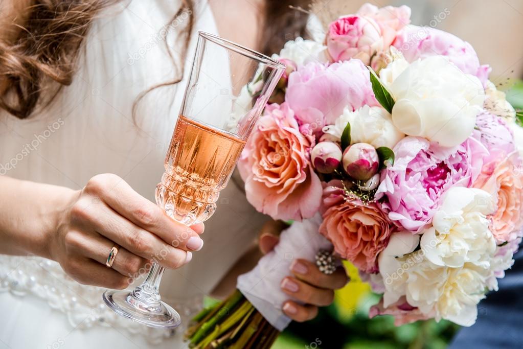 Beautiful bridal bouquet and glass of champagne