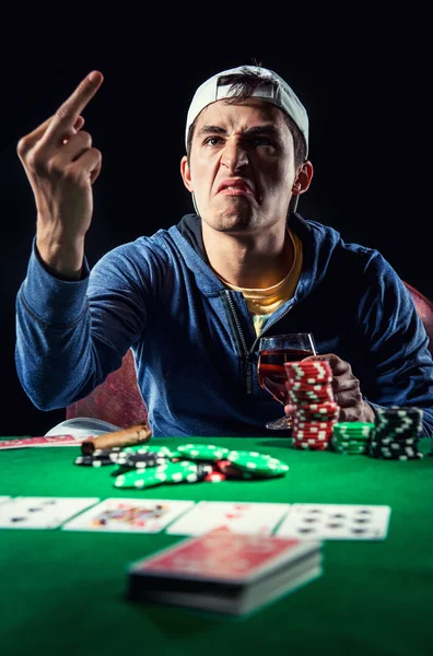 Agressive young gambler indoors — Stock Photo, Image