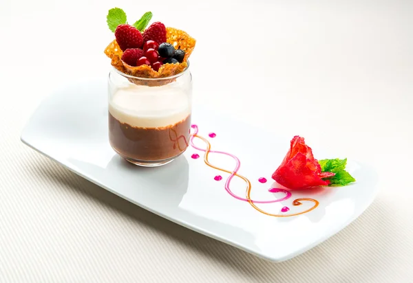 Waffle basket with fresh berries and cup of chocolate cream — Stock Photo, Image