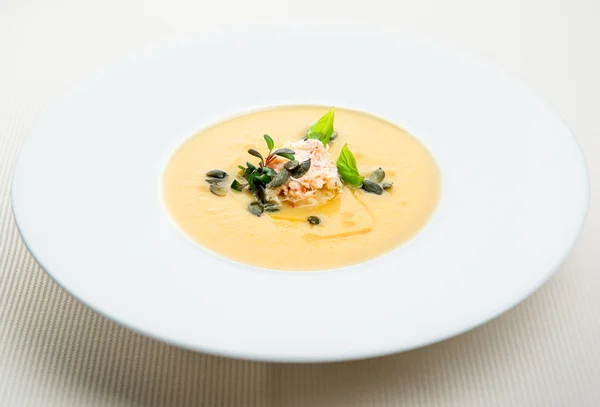 Pumpkin crab soup on a white bowl — Stock Photo, Image