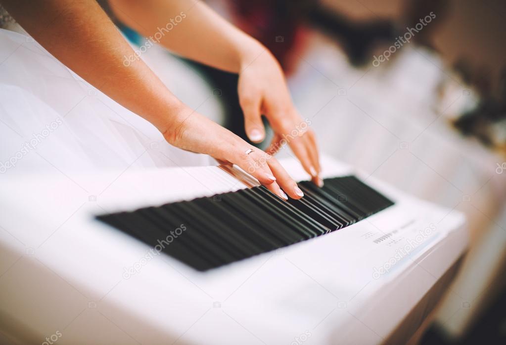 Woman hands playing the piano