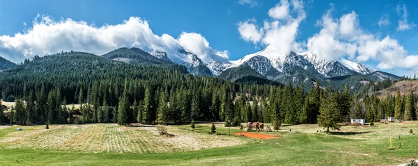 Picturesque landscape with empty playground and High Tatras — Stock Photo, Image