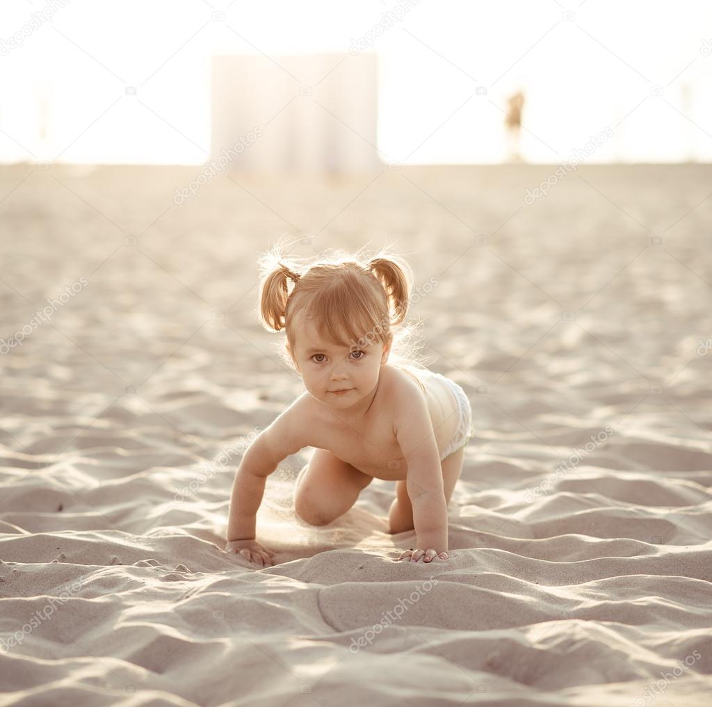 Adorable baby girl on the beach Stock Photo by ©amoklv 50569215
