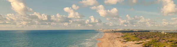 Aerial drone point of view sandy beach of La Mata and Mediterranean sea in the early morning, horizontal image. Costa Blanca, Spain. Summer holidays and travel concept