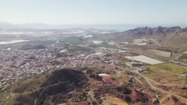 Aerial shot, drone point of view Murcia townscape countryside and mines of Mazarron in Murcia on blue sky background during sunny summer day. Spain