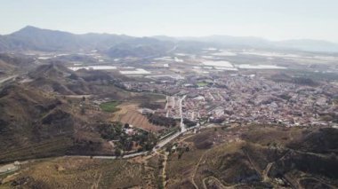 Aerial shot, drone point of view Murcia townscape countryside and mines of Mazarron in Murcia on blue sky background during sunny summer day. Spain