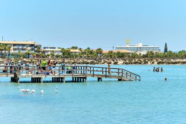 San Pedro del Pinatar, Spain - July 11, 2022: Waterside view, people, tourists visit therapeutic mud baths and salt flats. Travel destinations. Costa Calida. Spain