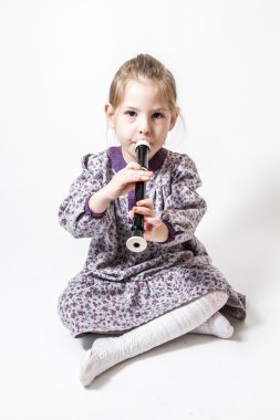Little Girl Playing The Flute clipart