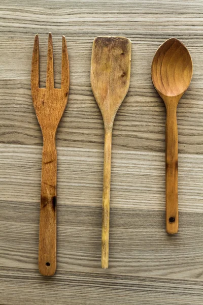 Kitchen wooden utensil of scapula, spoon and fork — Stock Photo, Image