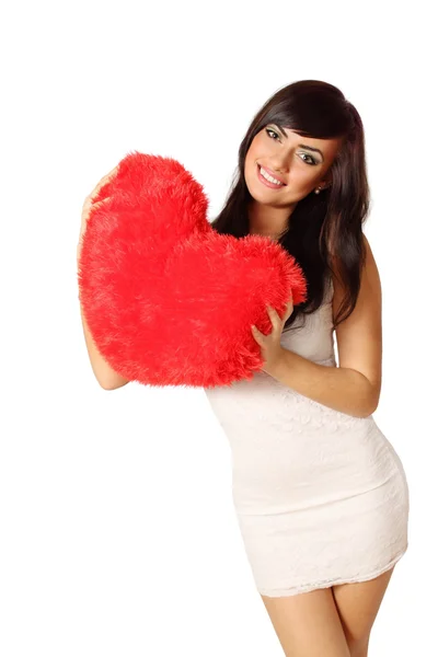 Woman holding heart-shaped pillow — Stock Photo, Image