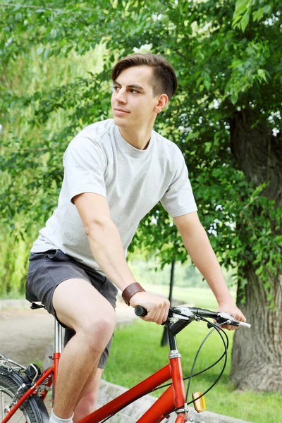 Young man riding a bike — Stock Photo, Image