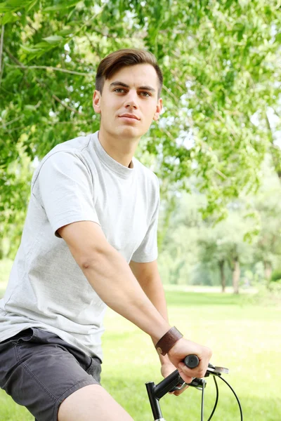 Friendly young guy on bicycle — Stock Photo, Image