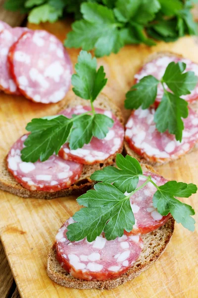 Sandwich with sausage and parsley — Stock Photo, Image