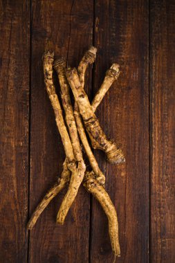 Ahşap zemin üzerinde baharatlı yabanturpu kökü, üst görünüm