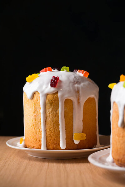 Easter cakes decorated with candied fruits and jelly eggs, close-up