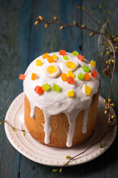 Easter cakes decorated with Jelly candy in the shape of an egg on a wooden background, copy space