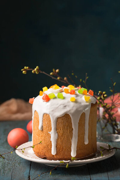 Easter cakes decorated with Jelly candy in the shape of an egg on a wooden background, copy space