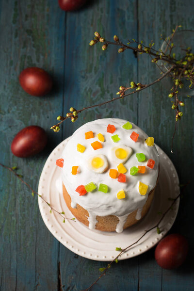 Easter cakes decorated with Jelly candy in the shape of an egg on a wooden background, copy space