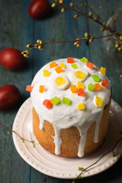 Easter cakes decorated with Jelly candy in the shape of an egg on a wooden background, copy space