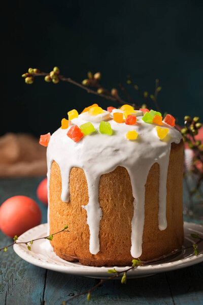 Easter cakes decorated with Jelly candy in the shape of an egg on a wooden background, copy space
