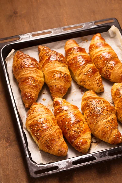 Big Croissants Metal Baking Sheets Wooden Background Top View — Stock Photo, Image