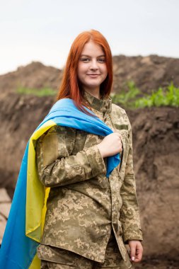 Ukrainian girl in the uniform of the armed forces of Ukraine in a trench