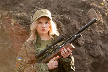 Siperde elinde silah olan güzel bir kız.