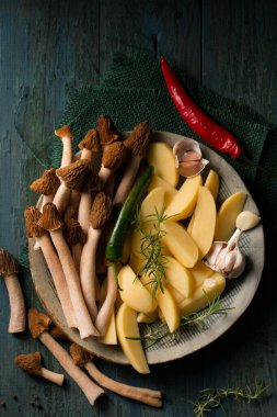 Morel forest mushrooms with raw potatoes and spicy spices