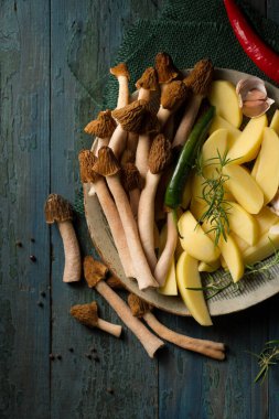 Morel forest mushrooms with raw potatoes and spicy spices