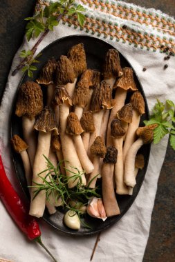 Morel forest mushrooms with spicy spices and aromatic vegetables