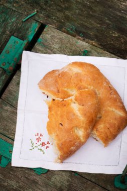 Baked pita bread with onions on a wooden background