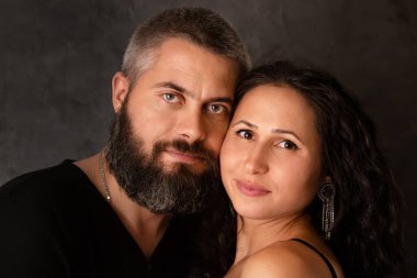 Portrait of a young couple in love on a dark background