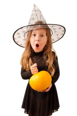 A little witch with a pumpkin isolated on white background. Halloween concept
