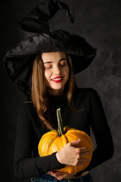 Charming Young Girl Witch Hat Pumpkin Her Hands — Stok fotoğraf