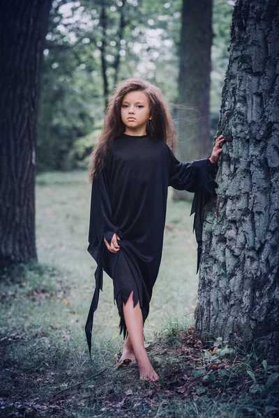 Una Niña Con Traje Bruja Bosque Cerca Árbol Concepto Halloween —  Fotos de Stock