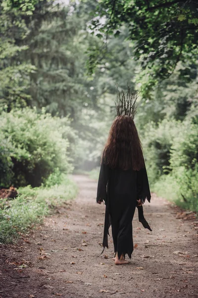 Una Joven Con Vestido Negro Una Corona Ramas Camina Oscuridad — Foto de Stock