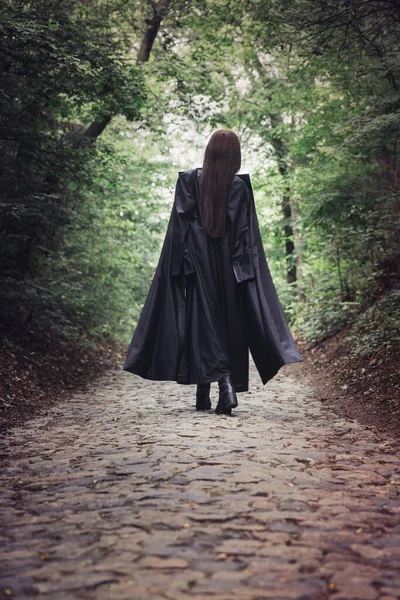 Tall Beautiful Woman Black Raincoat Walks Dense Forest Back View — Stock Photo, Image