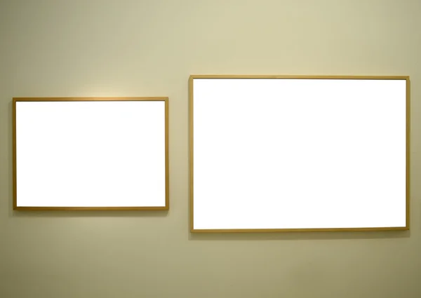 Blank picture frames on gallery wall — Stock Photo, Image