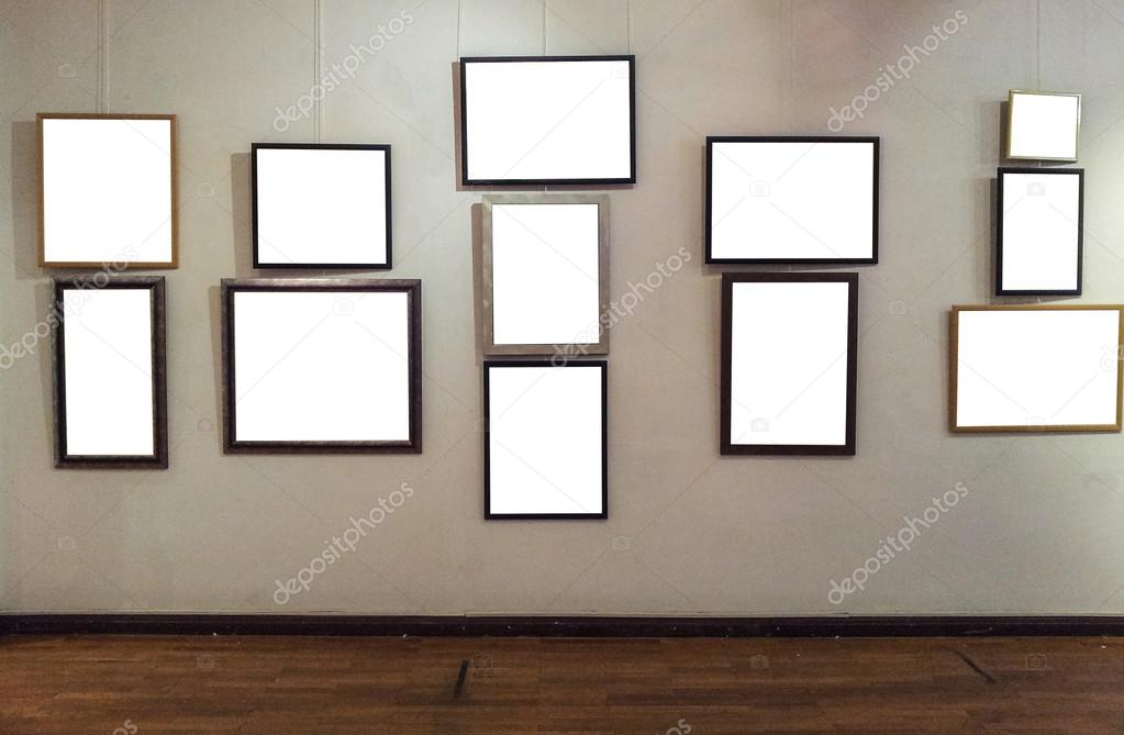 Blank photo frames on gallery wall