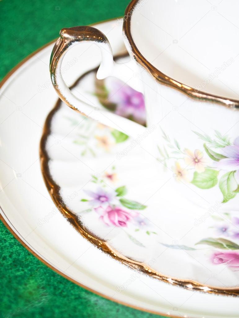 Vintage tea or coffee cup with floral pattern macro shot