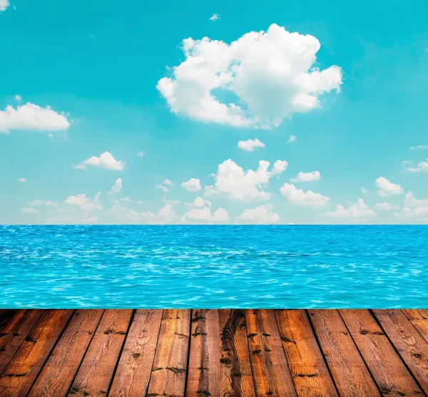 Blue ocean and sky above wood plank floor — Stock Photo, Image