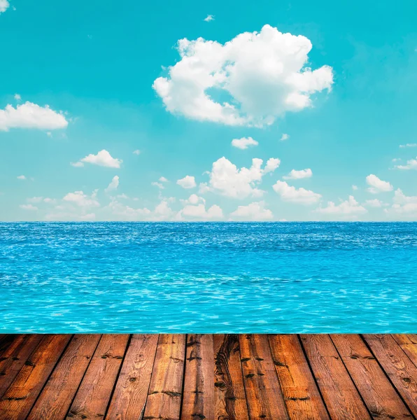 Blue ocean and sky above wooden floor — Stock Photo, Image