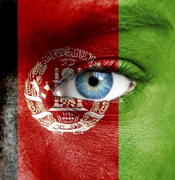 Human face painted with flag of Afghanistan — Stock Photo, Image