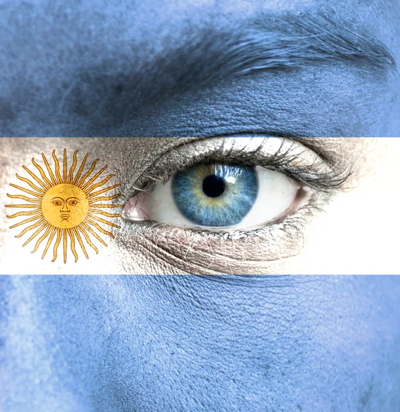 Human face painted with flag of Argentina — Stock Photo, Image