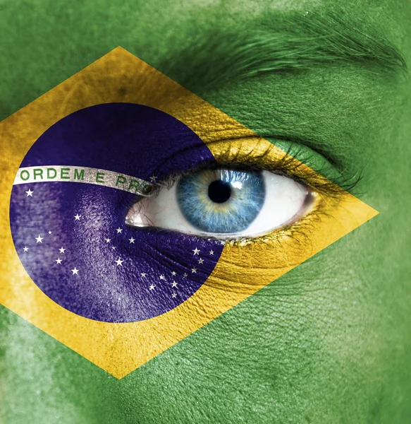 Human face painted with flag of Brazil — Stock Photo, Image