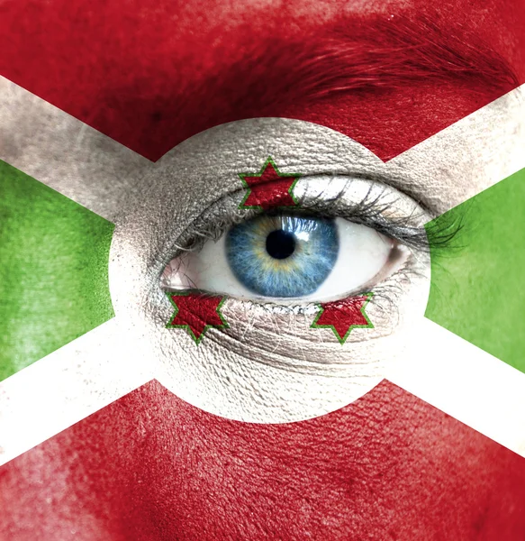 Human face painted with flag of Burundi — Stock Photo, Image