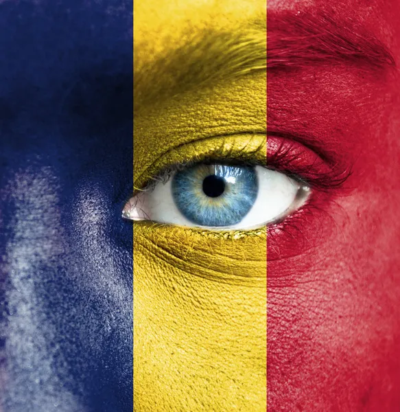 Human face painted with flag of Chad — Stock Photo, Image