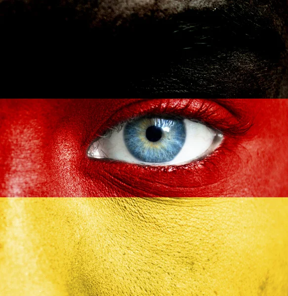 Menschengesicht mit Deutschland-Fahne bemalt — Stockfoto